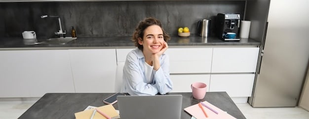 A person sitting at a tidy desk in a home office, smiling calmly while wearing headphones. The background shows blurred images of plants and natural light, representing a serene and focused atmosphere.