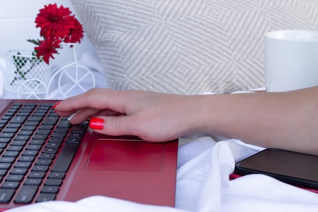 A person's hands typing quickly on a laptop keyboard in a well-lit home office. Focus is on the fingers and the keys being pressed.