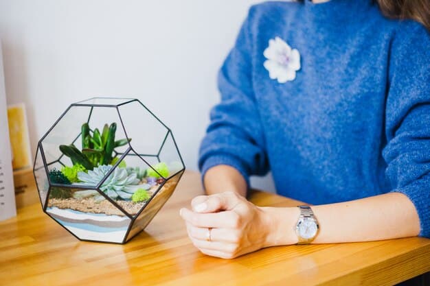 A close-up shot of hands gently holding a small potted plant on a desk in a home office, symbolizing growth, tranquility, and mindfulness in a workspace.