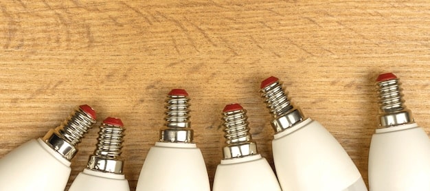 A selection of different light bulbs, including LED, CFL, and incandescent, with their Kelvin and lumen ratings displayed prominently.