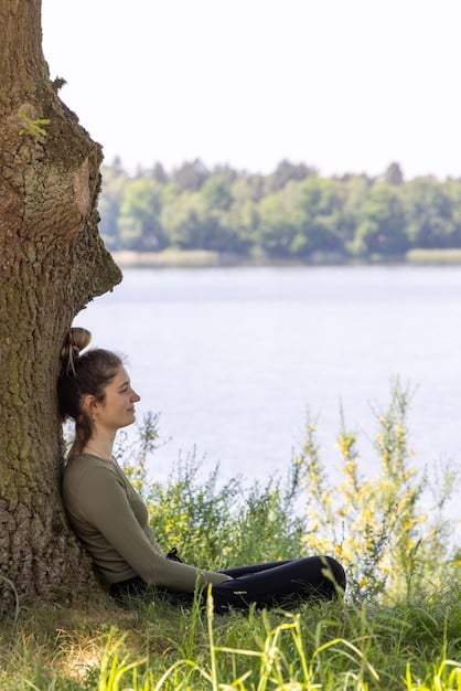 A person outdoors, taking a deep breath in a natural setting during a break, with trees and clear sky in the background, symbolizing rejuvenation.