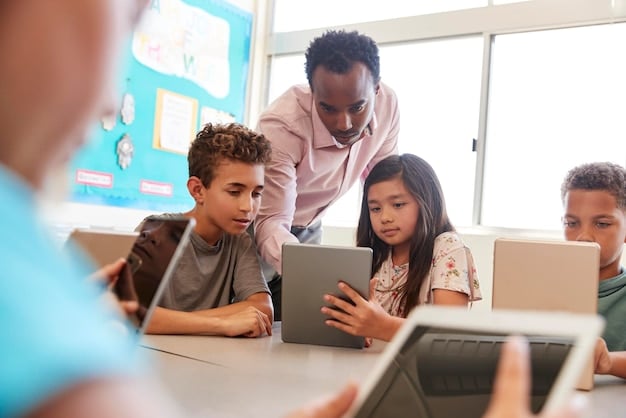 An elementary school classroom in the US where students are using tablets and educational software, guided by their teacher, illustrating the use of technology in early education.