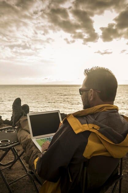 A split-screen image. One side shows a digital nomad working on a laptop in a cozy, well-lit RV parked in a scenic national park. The other side shows a digital nomad using a laptop inside a stylish co-living space.