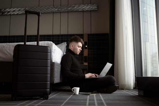 A person is shown securing their laptop and other electronic devices in a portable travel safe inside a hotel room. Emphasis is on the security measures being taken.