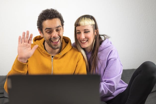 Two people participating in a video call and fist-bumping, looking happy.