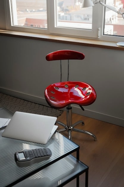 A minimalist, clutter-free home office setup with a comfortable chair, ergonomic keyboard, and natural light.