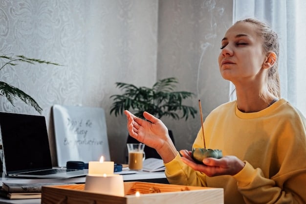 A person practicing mindfulness meditation during a break at their desk, with eyes closed and hands gently resting in their lap.