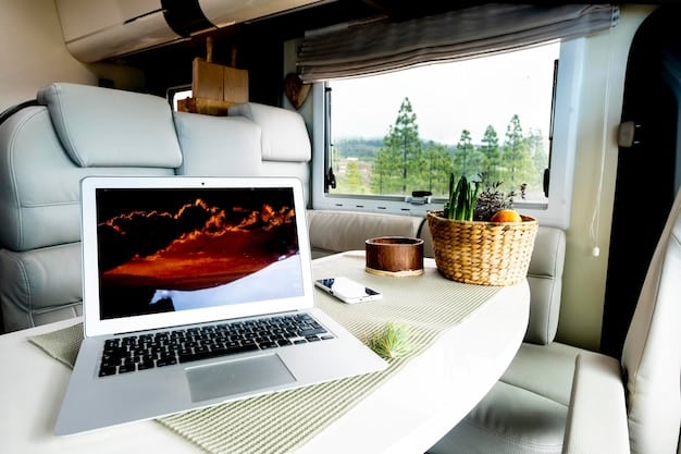 Interior of a well-equipped RV with a dedicated workspace featuring a desk, ergonomic chair, laptop, and multiple screens, suggesting a comfortable and productive remote work environment.