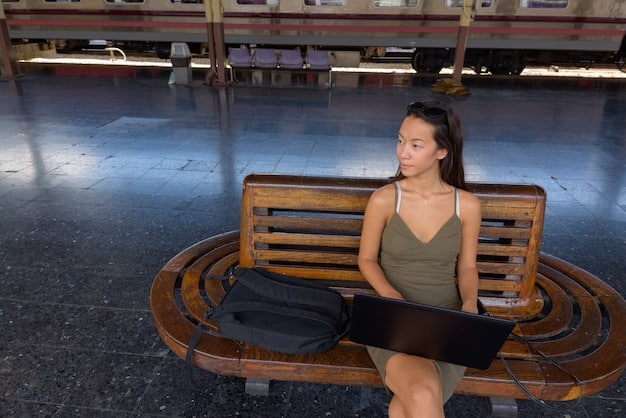 A digital nomad securing their laptop to a table in a public space using a laptop lock, emphasizing physical security of devices.