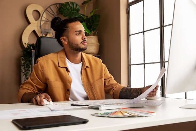 A freelancer sitting at a desk, using a laptop with a spreadsheet or a budgeting software open on the screen. They are also reviewing physical invoices or receipts, suggesting a thorough approach to tracking income and expenses.