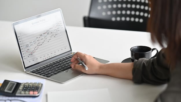 A close-up of a freelancer's hands working on a laptop, with a focus on a spreadsheet showing income and expenses. The background is blurred to keep the focus on the financial data.