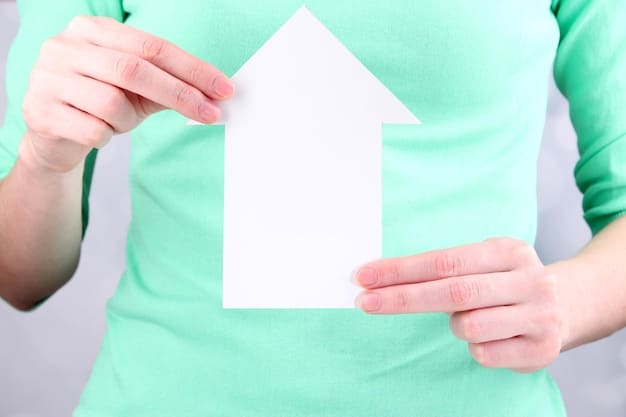 A close-up of a hand holding a small house figure, with a background of legal documents, representing home-based business insurance for freelancers.