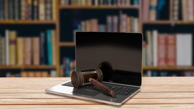 A gavel resting on a stack of legal books with a laptop in the background, symbolizing the intersection of technology and law.