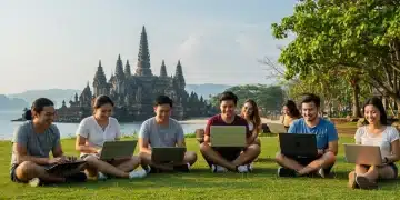 Digital nomads working outdoors in a scenic Southeast Asian location with temple and beach views.